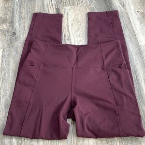 Athleta High Rise Maroon Leggings with Side pockets and ankle slits, size medium